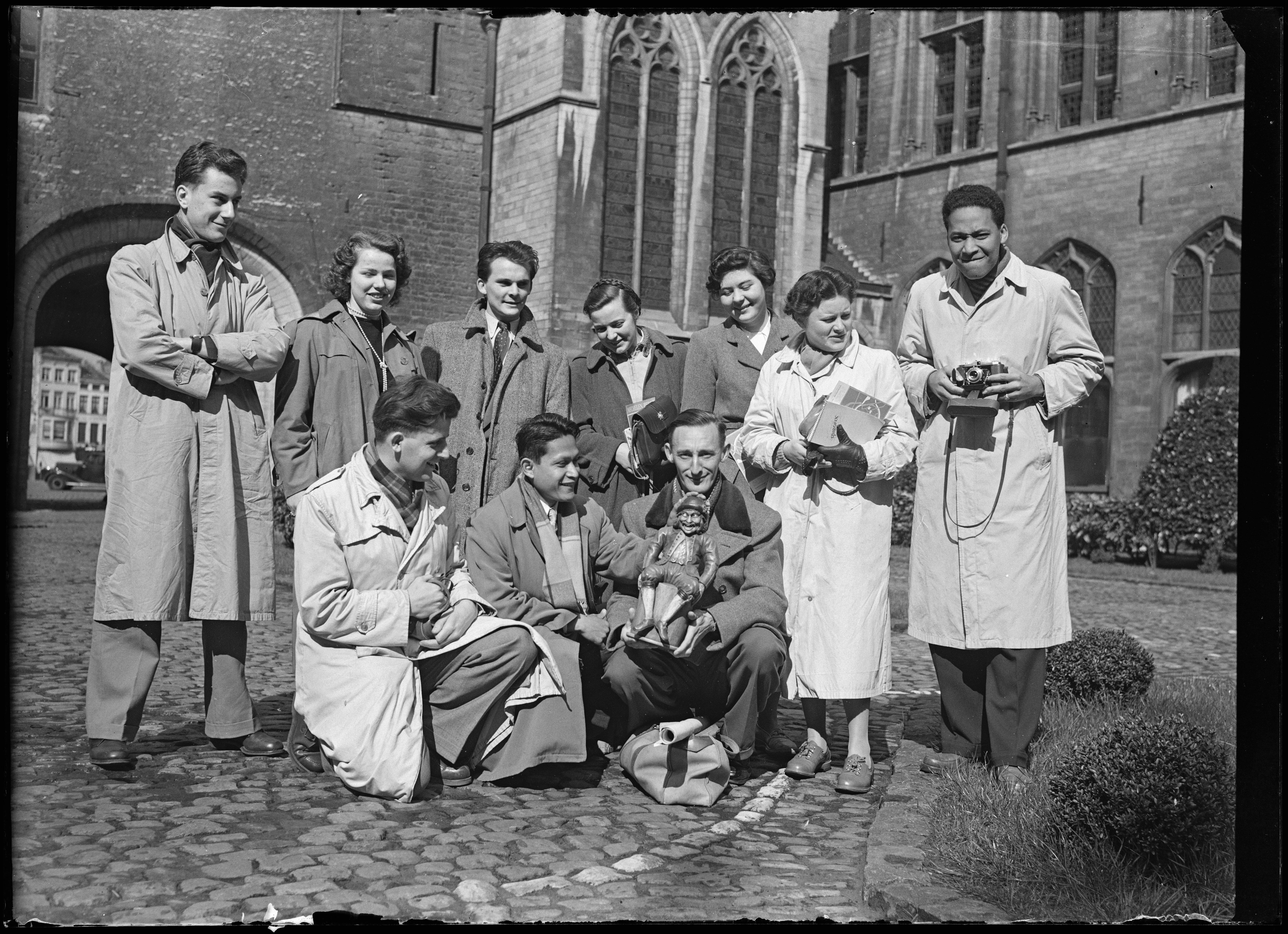 Buitenlandse toeristen op de binnenplaats van het Mechelse stadhuis, 1953. Foto door Leon Van Baelen